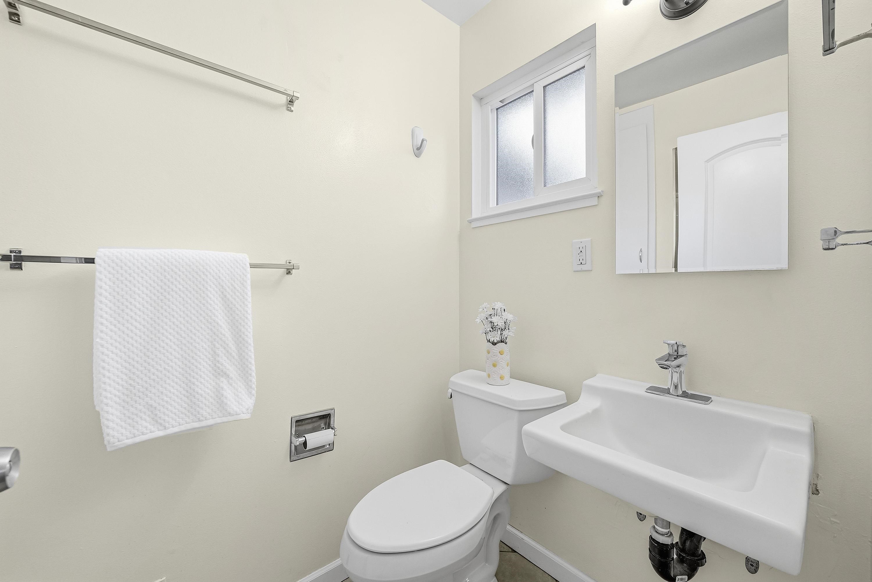 4214 Wells Street Pleasanton, CA 94566 - Photo 24 of 38 a white toilet sitting next to a bathroom sink