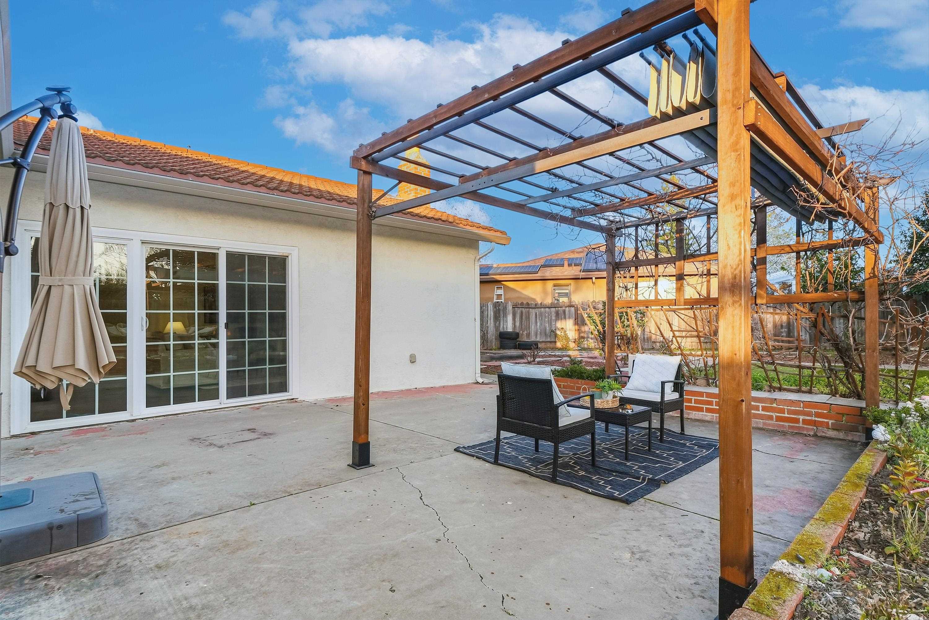 4214 Wells Street Pleasanton, CA 94566 - Photo 33 of 38 a view of a patio with table and chairs and wooden floor