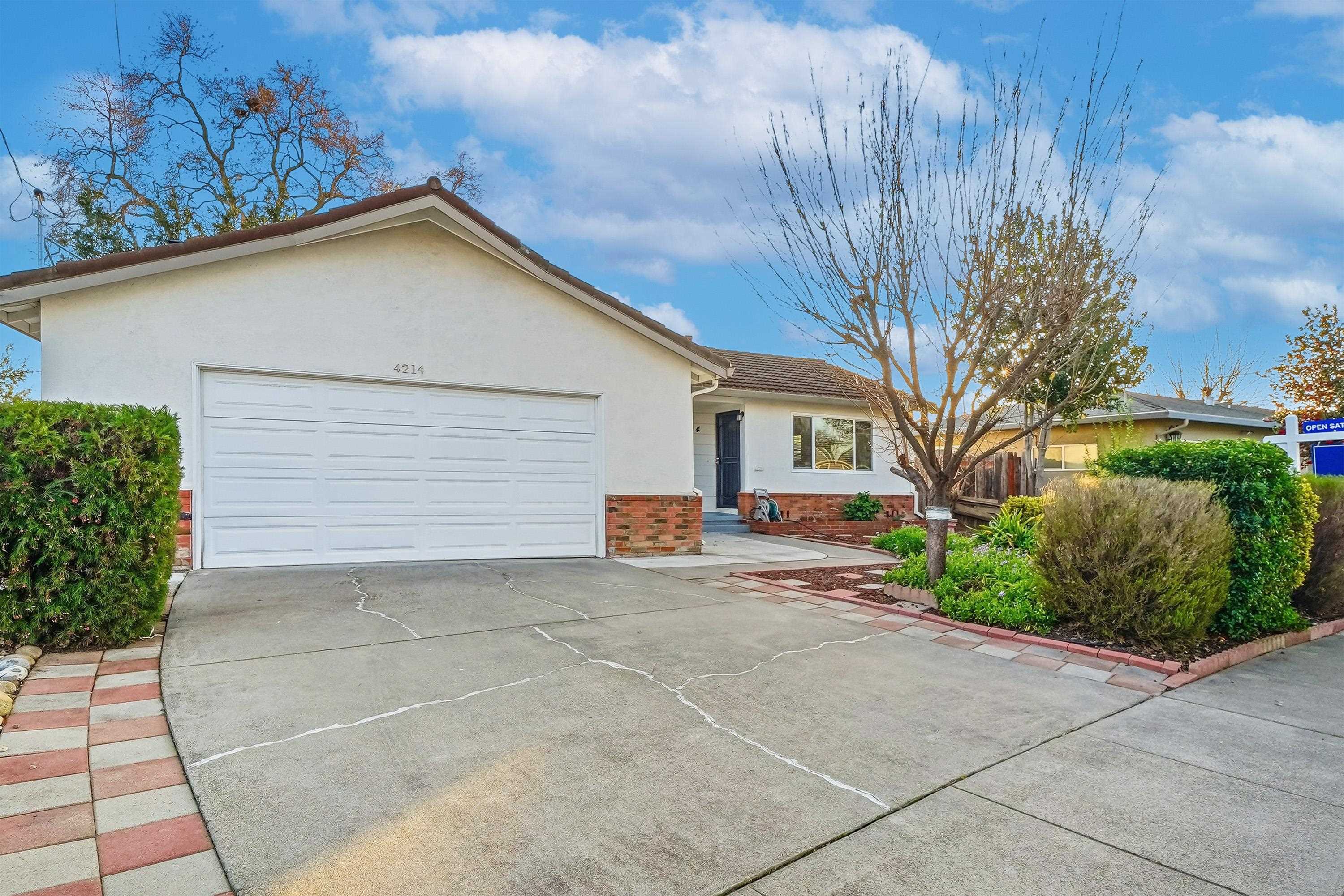 4214 Wells Street Pleasanton, CA 94566 - Photo 5 of 38 a view of a house with a yard and garage