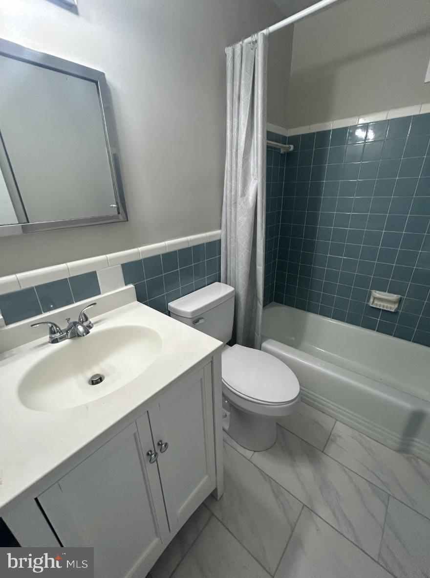8601 Manchester Road, Unit 217 Silver Spring, MD 20901 - Photo 3 of 3 a bathroom with a sink toilet and shower