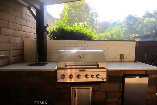 a view of a stove with two chairs
