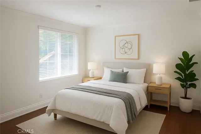 a bedroom with a bed and a potted plant