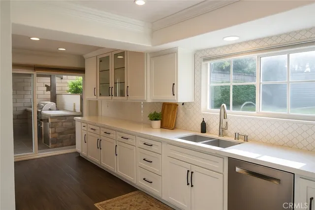 a kitchen with sink cabinets and window