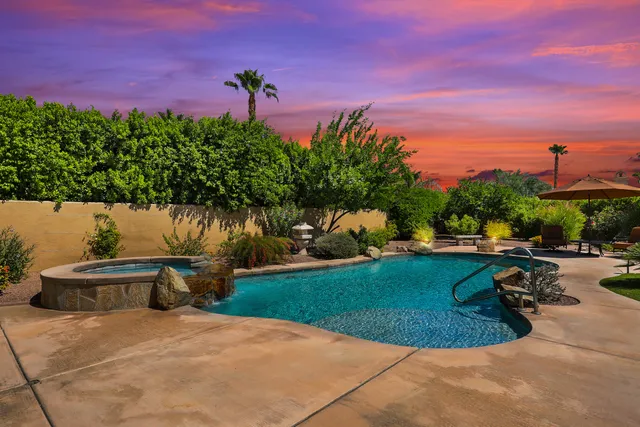 a spacious bedroom with a bed a couch and a flat screen tv