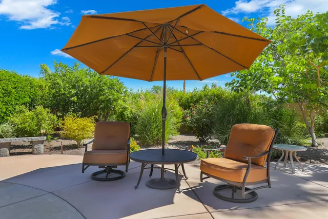a bathroom with double vanity sinks a toilet a mirror and shower