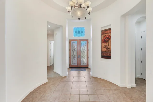 a white bed sitting in a bathroom next to a window