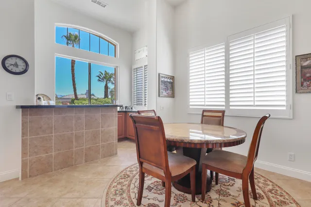 a view of a house with swimming pool and sitting area