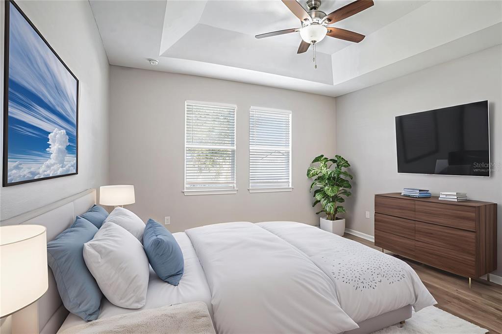 12314 Eagle Swoop Place Riverview, FL 33579 - Photo 11 of 23 a bedroom with a bed and a flat screen tv