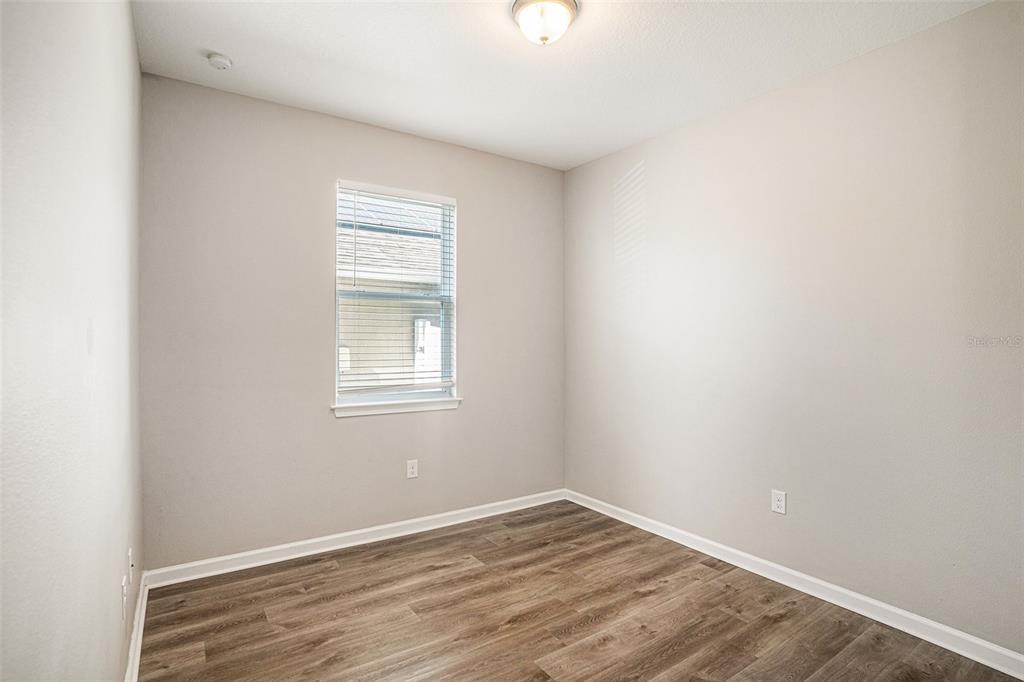 12314 Eagle Swoop Place Riverview, FL 33579 - Photo 15 of 23 a view of an empty room with wooden floor and a window