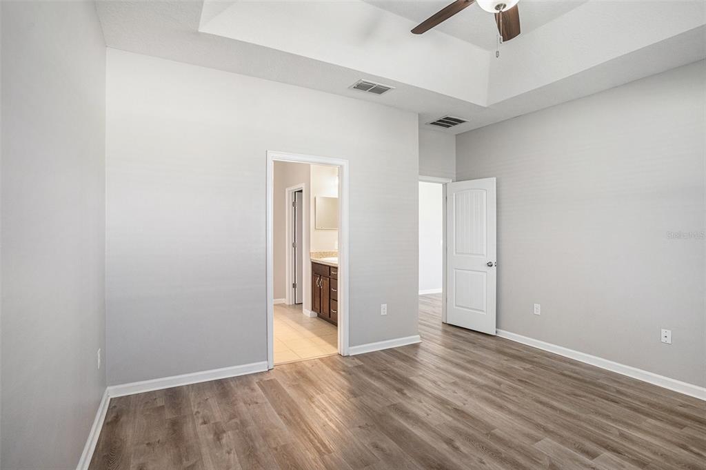 12314 Eagle Swoop Place Riverview, FL 33579 - Photo 17 of 23 a view of an empty room with wooden floor