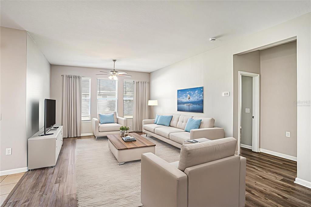 12314 Eagle Swoop Place Riverview, FL 33579 - Photo 5 of 23 a living room with furniture wooden floor and a flat screen tv