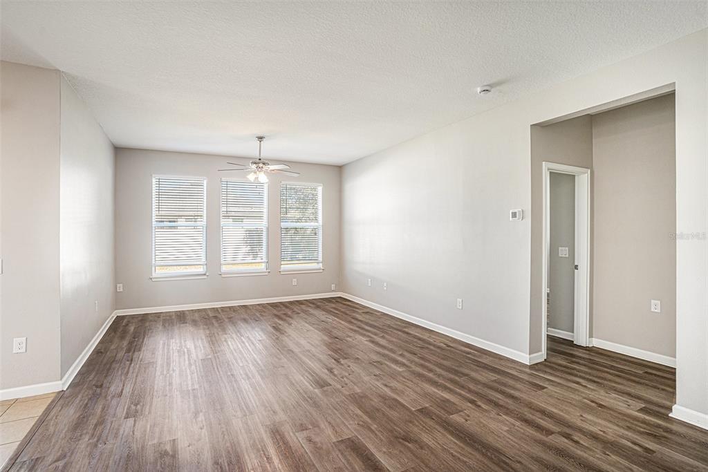 12314 Eagle Swoop Place Riverview, FL 33579 - Photo 6 of 23 a view of an empty room with wooden floor and a window