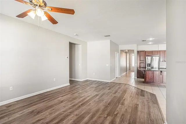 a kitchen with stainless steel appliances granite countertop a refrigerator and a stove top oven