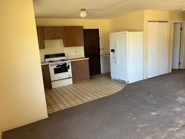 a kitchen with stainless steel appliances a refrigerator and a stove