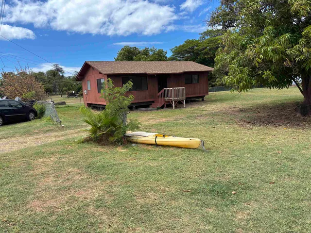 a view of a house with a yard patio and a fire pit
