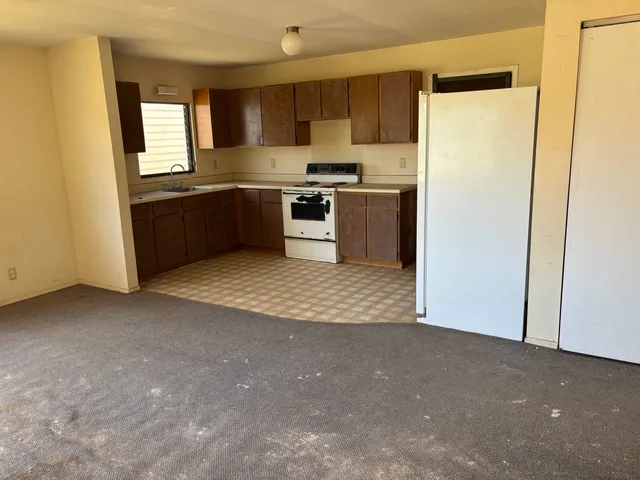 a view of a kitchen with a sink cabinets and a window
