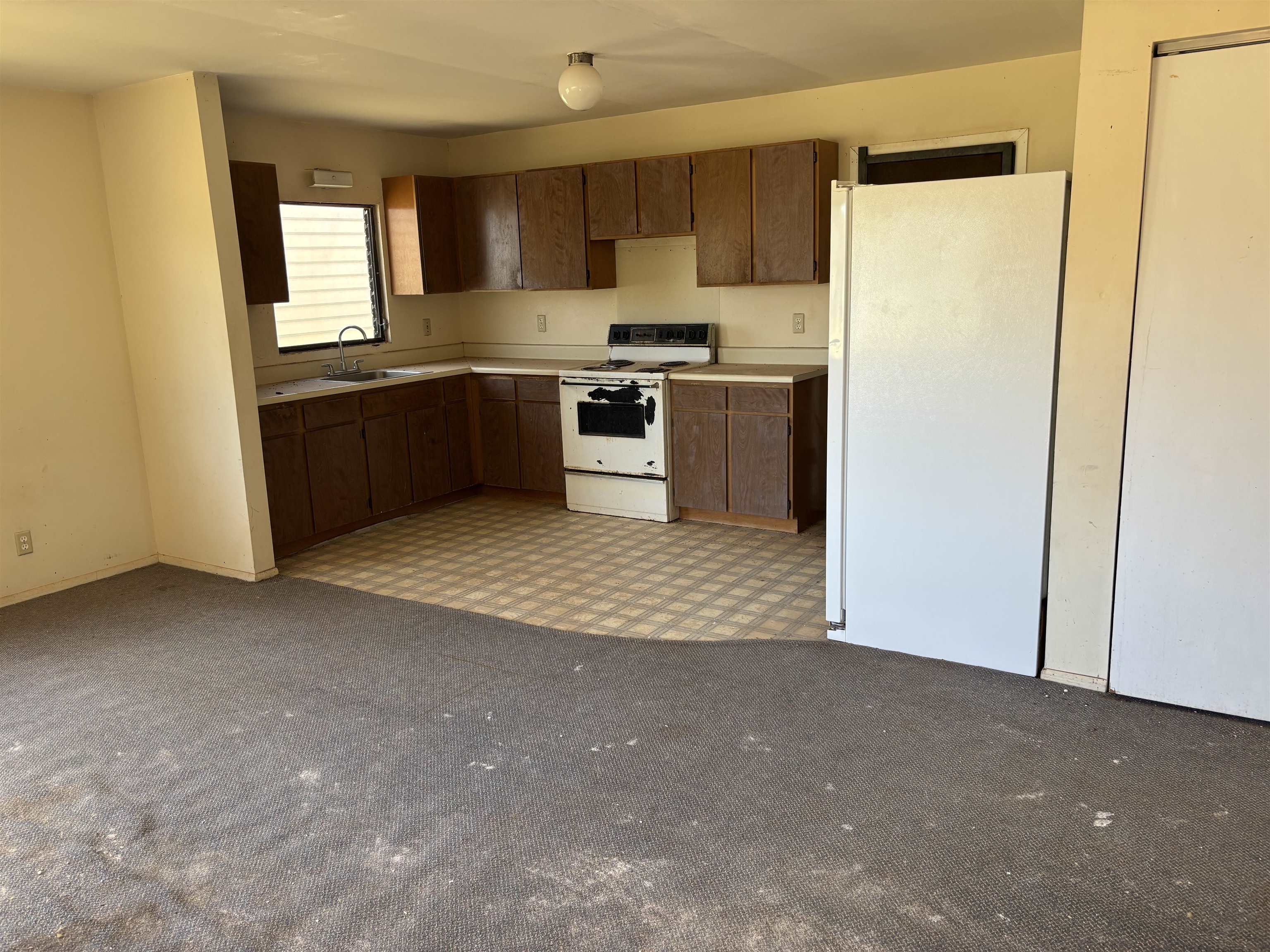 260 Seaside Street Kaunakakai, HI 96748 - Photo 10 of 17 a view of a kitchen with a sink cabinets and a window