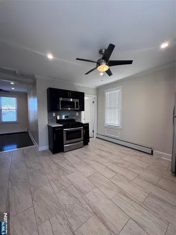 a view of kitchen with microwave stove and cabinets