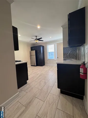 a living room with kitchen island furniture and a flat screen tv