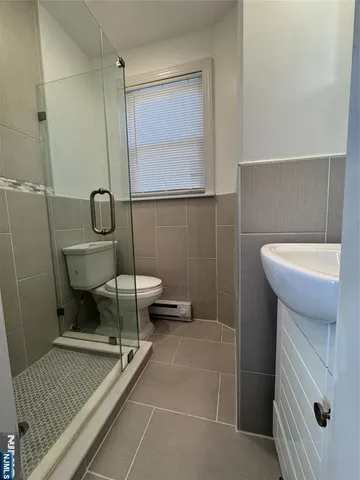 a bathroom with a sink a toilet and mirror