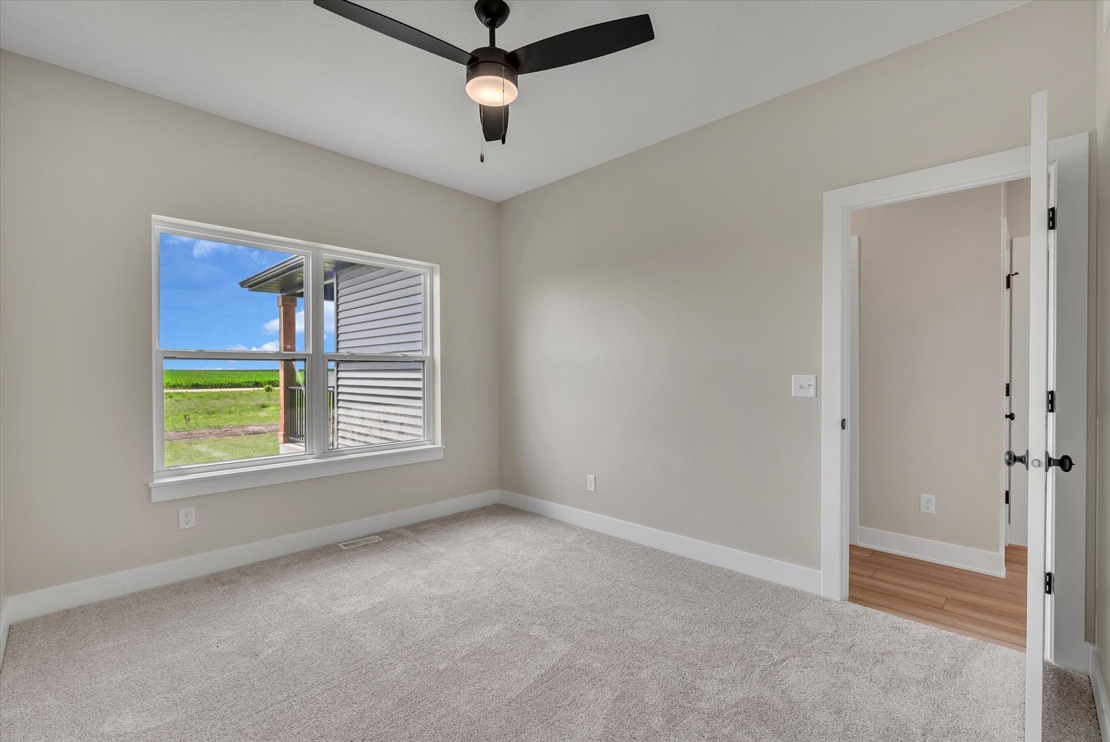455 Rhonda Road New Liberty, IA 52765 - Photo 40 of 54 an empty room with a window and a ceiling fan