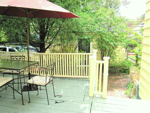 70-72 Beaconsfield Road Brookline, MA 02445 - Photo 18 of 22 a view of a chair and tables under an umbrella