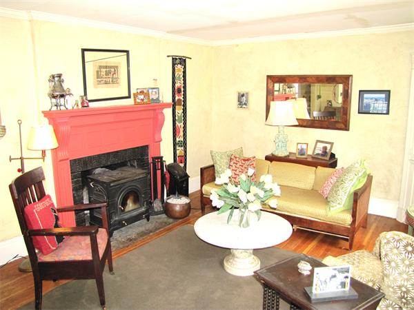 70-72 Beaconsfield Road Brookline, MA 02445 - Photo 4 of 22 a living room with furniture a fireplace and a large mirror