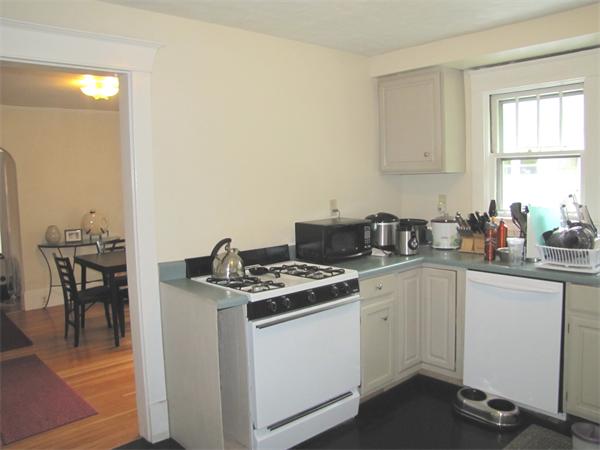 70-72 Beaconsfield Road Brookline, MA 02445 - Photo 10 of 22 a kitchen with a stove and white cabinets