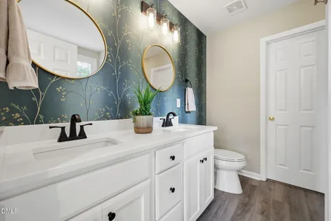 a bathroom with 2 sink and a mirror