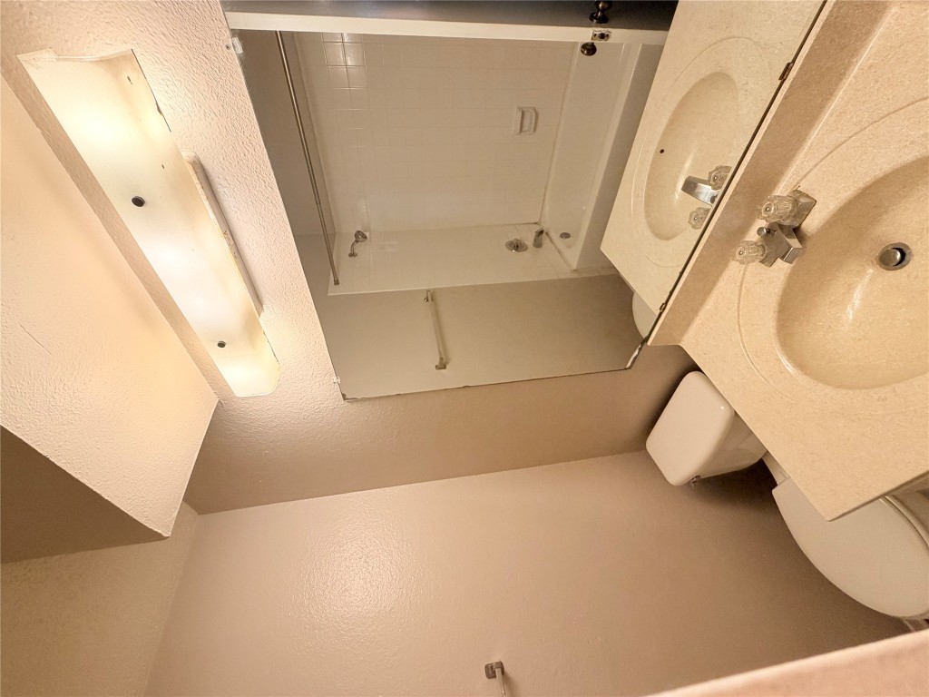 12800 Tomanet Trail, Unit B Austin, TX 78727 - Photo 8 of 12 a bathroom with a sink and mirror with toilet