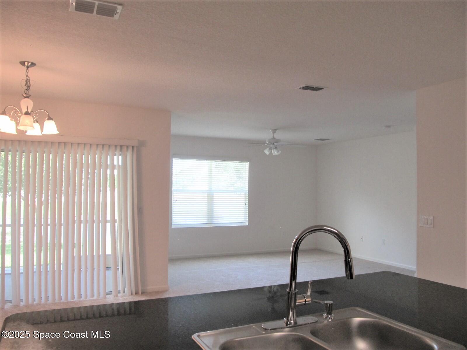 2002 Elkins Point Melbourne, FL 32935 - Photo 4 of 25 Kitchen to Living Room View