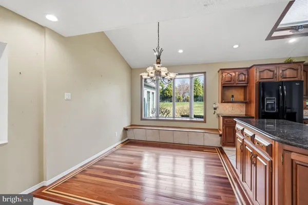 a view of wooden floor fire place and windows in a room
