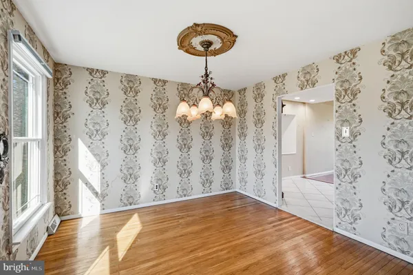 a view of a room with window and wooden floor