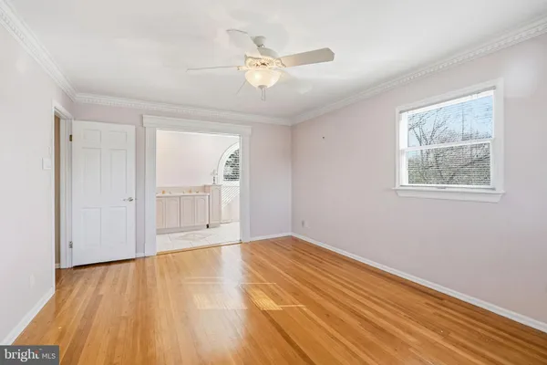 a view of a livingroom with wooden floor and a window