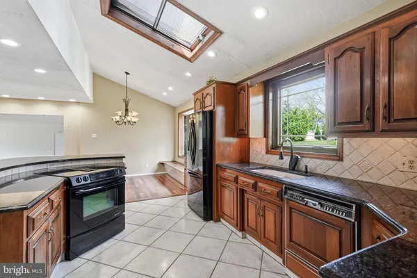 a kitchen with stainless steel appliances granite countertop a stove and a sink