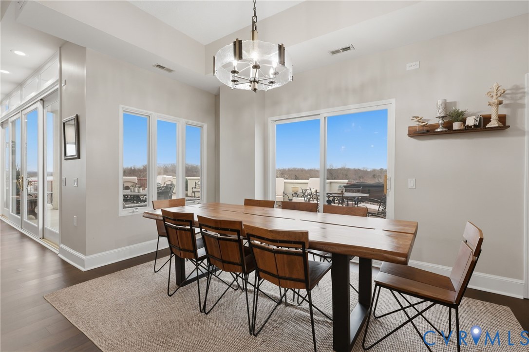 301 Beacon Ridge Drive, Unit 804 Hopewell, VA 23860 - Photo 17 of 64 a dining room with furniture a chandelier and wooden floor