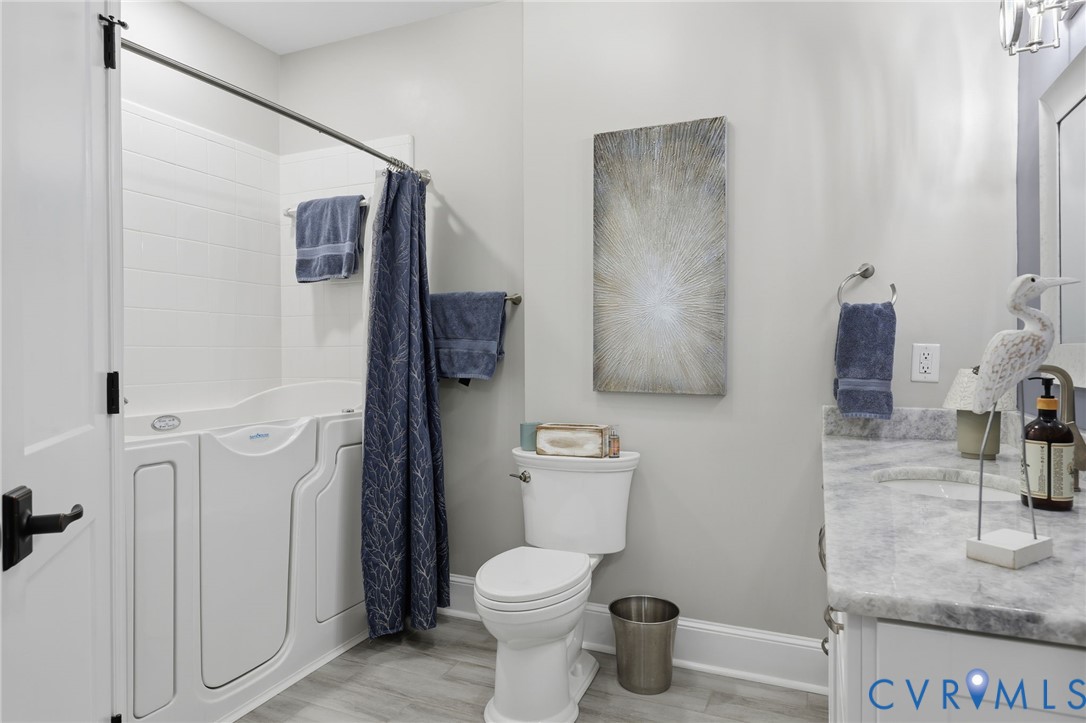 301 Beacon Ridge Drive, Unit 804 Hopewell, VA 23860 - Photo 30 of 64 a bathroom with a toilet sink and shower