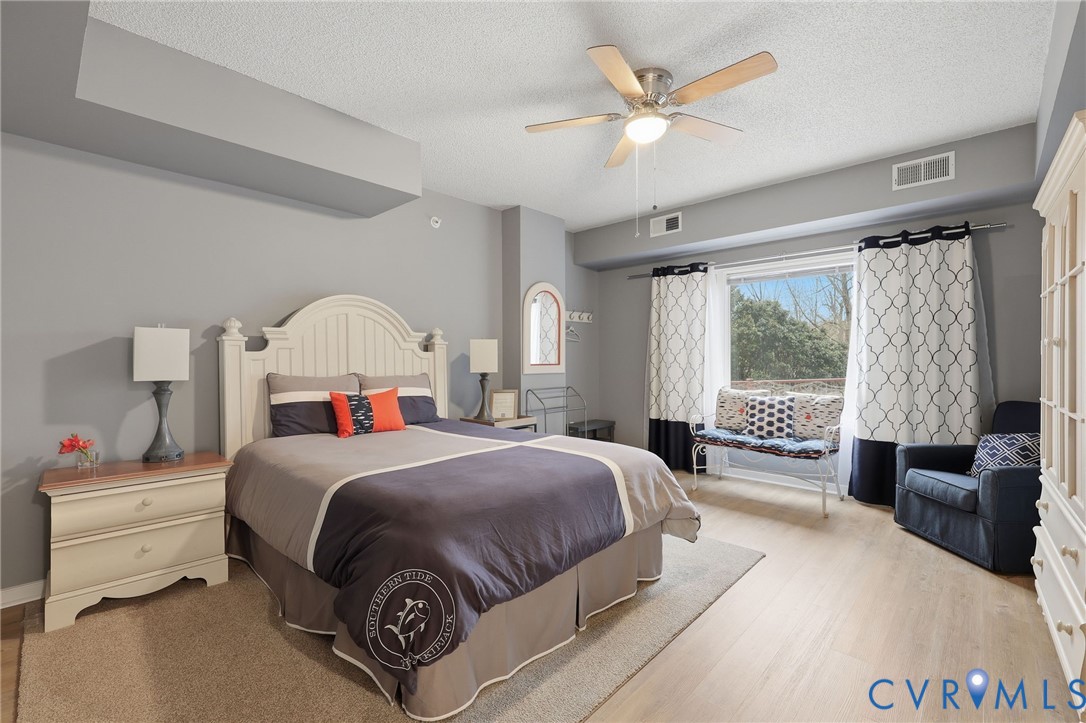 301 Beacon Ridge Drive, Unit 804 Hopewell, VA 23860 - Photo 45 of 64 a bedroom with a bed and a large window