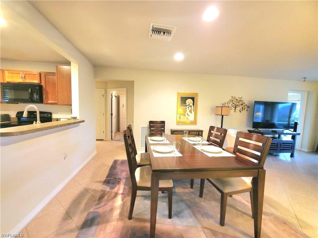 8657 Querce Court Naples, FL 34114 - Photo 19 of 44 a view of a dining room with furniture and a livingroom
