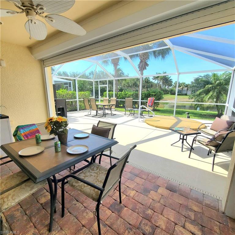 8657 Querce Court Naples, FL 34114 - Photo 29 of 44 a living room with patio furniture and a large window