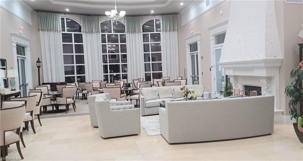 8657 Querce Court Naples, FL 34114 - Photo 34 of 44 a living room with furniture and large windows