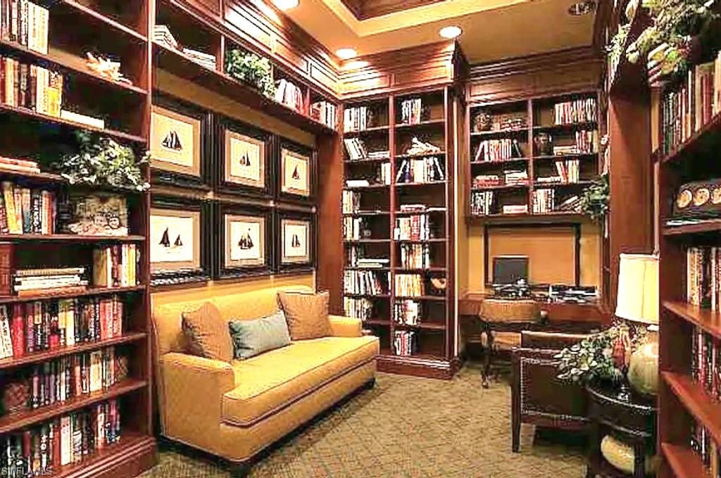 8657 Querce Court Naples, FL 34114 - Photo 40 of 44 a living room with furniture a bookshelf and a bookshelf