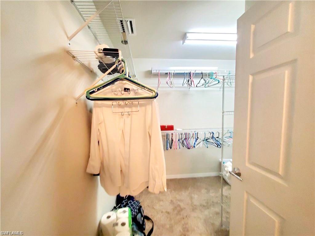 8657 Querce Court Naples, FL 34114 - Photo 10 of 44 a view of a hallway with painted walls