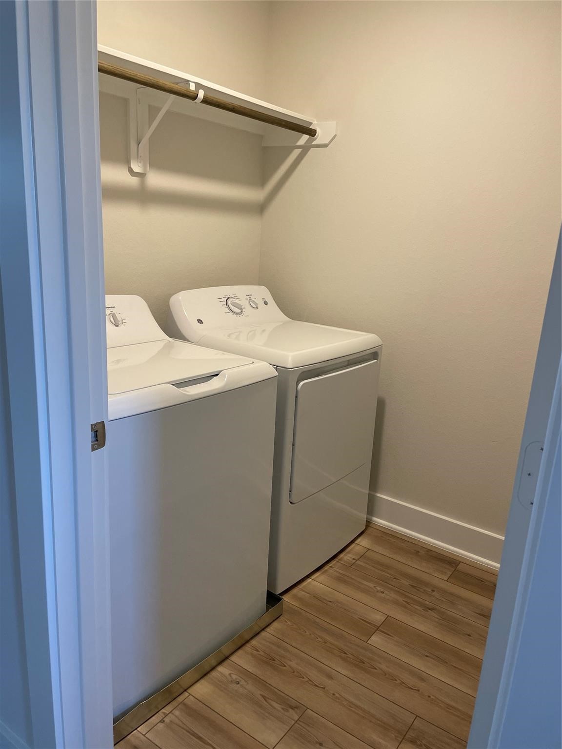 10638 Whitejacket Conroe, TX 77385 - Photo 6 of 25 a utility room with wooden floor washer and dryer