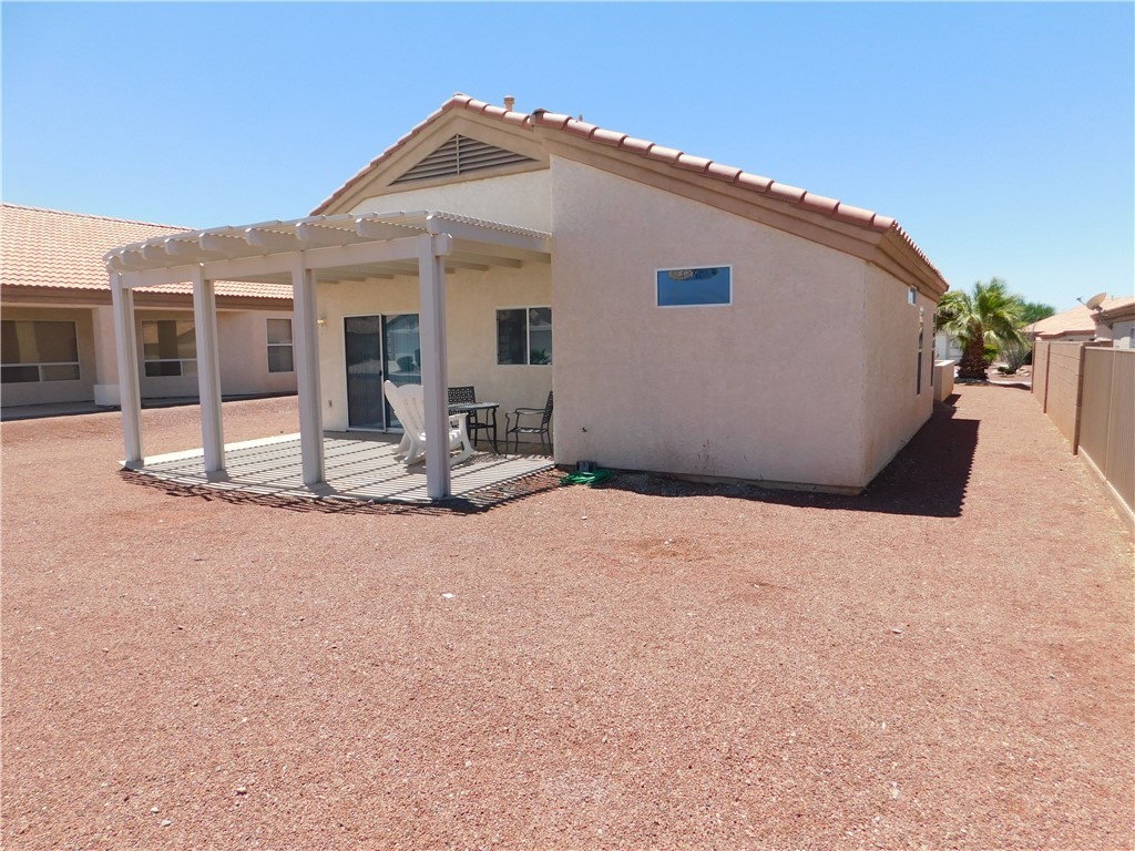2449 Wilder Road Bullhead City, AZ 86442 - Photo 11 of 45 a view of a house with backyard and sitting area