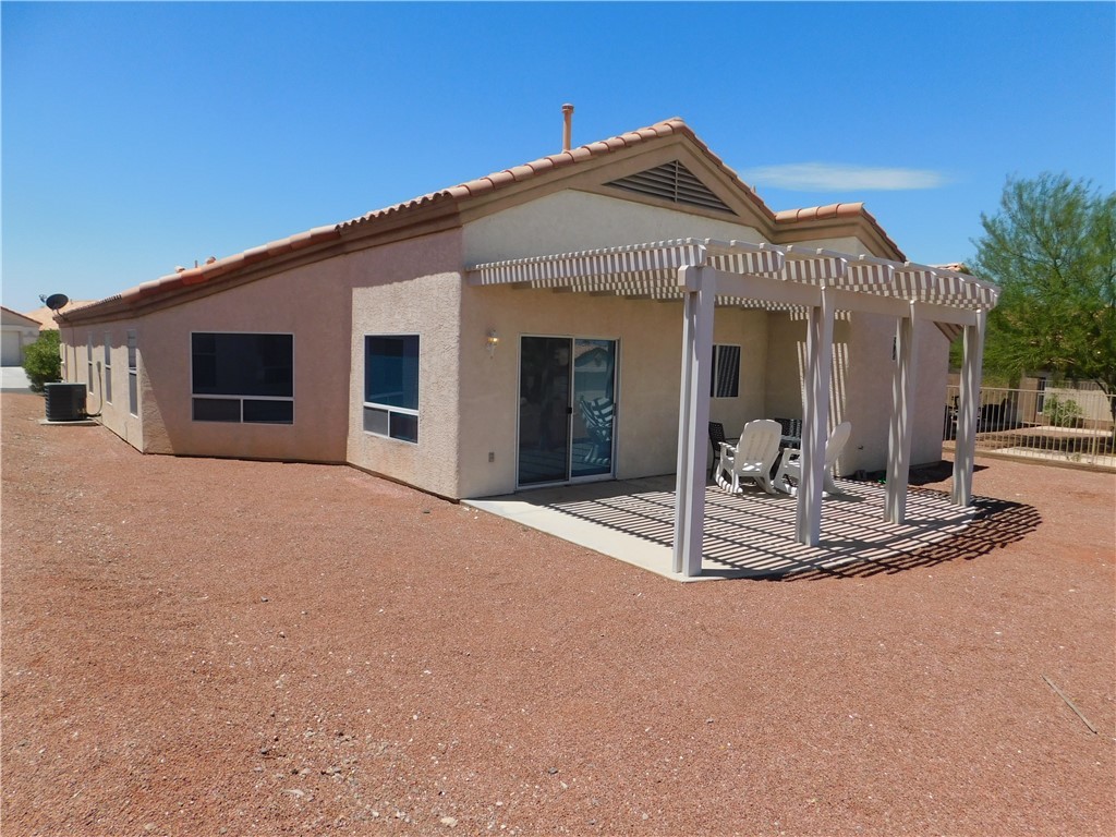 2449 Wilder Road Bullhead City, AZ 86442 - Photo 17 of 45 a view of a house with wooden floor and backyard