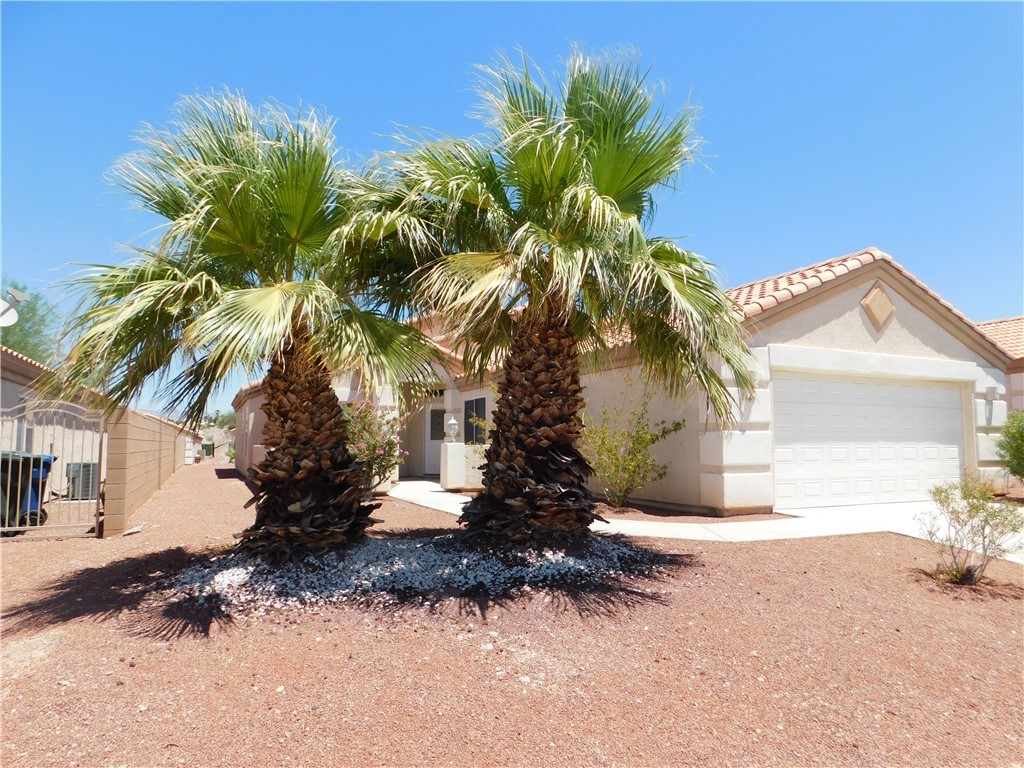 2449 Wilder Road Bullhead City, AZ 86442 - Photo 2 of 45 a view of a house with a tree in the background