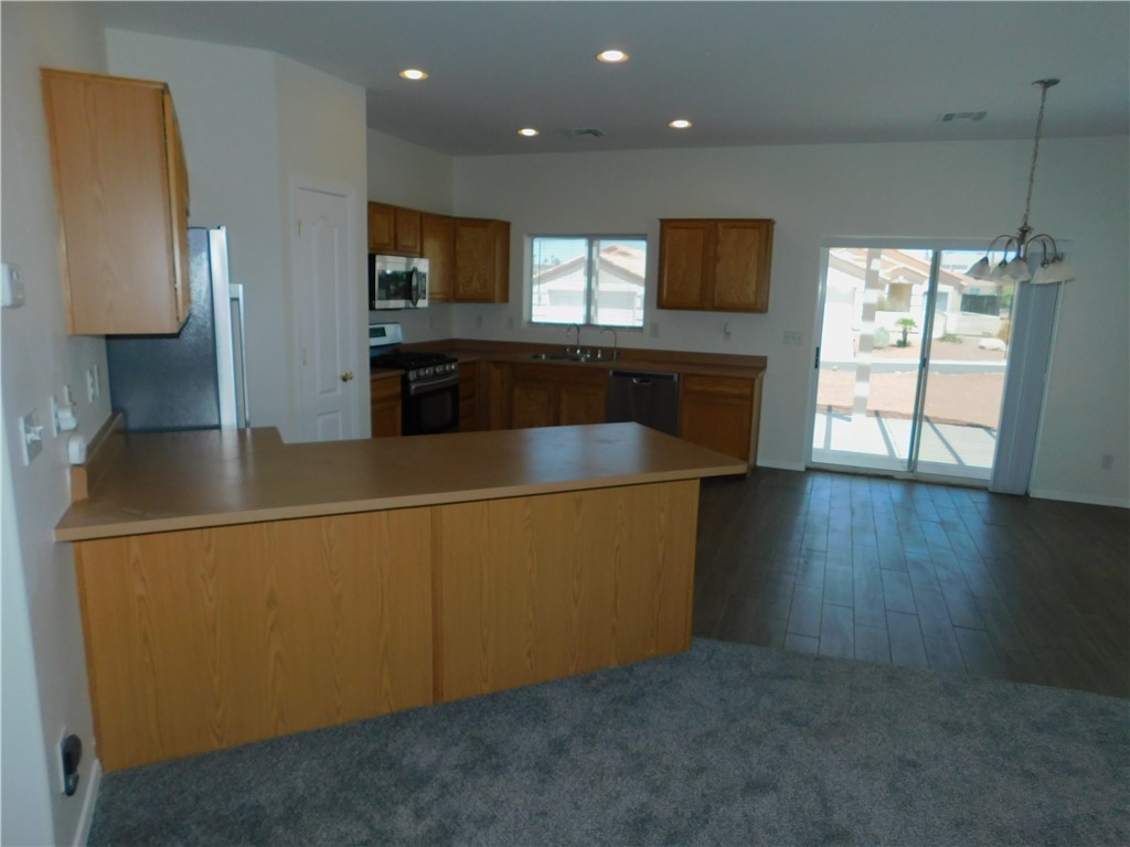 2449 Wilder Road Bullhead City, AZ 86442 - Photo 21 of 45 a kitchen with stainless steel appliances a refrigerator and a microwave