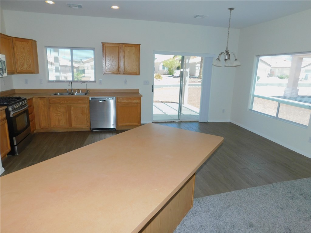 2449 Wilder Road Bullhead City, AZ 86442 - Photo 24 of 45 a kitchen with a stove a sink and a window