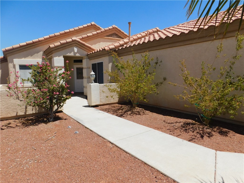 2449 Wilder Road Bullhead City, AZ 86442 - Photo 4 of 45 a front view of a house with a yard